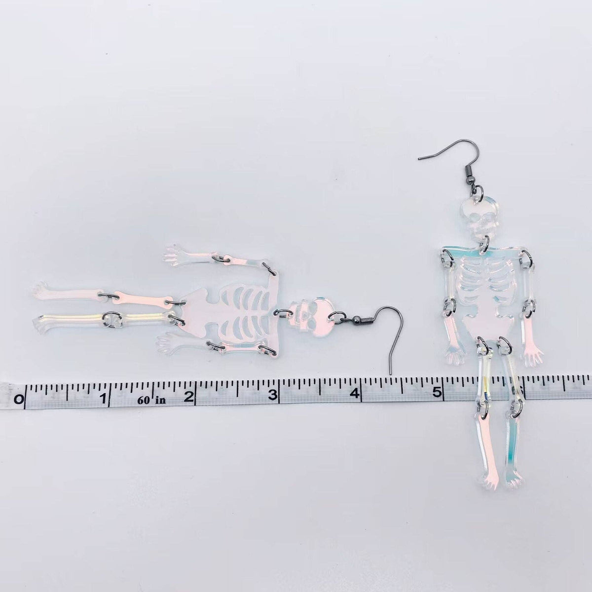 
                  
                    Iridescent Acrylic Skeleton Earrings
                  
                