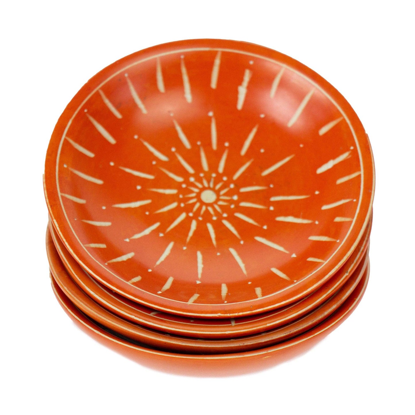 
                  
                    Stack of orange ceramic plates with white starburst pattern on a white background
                  
                