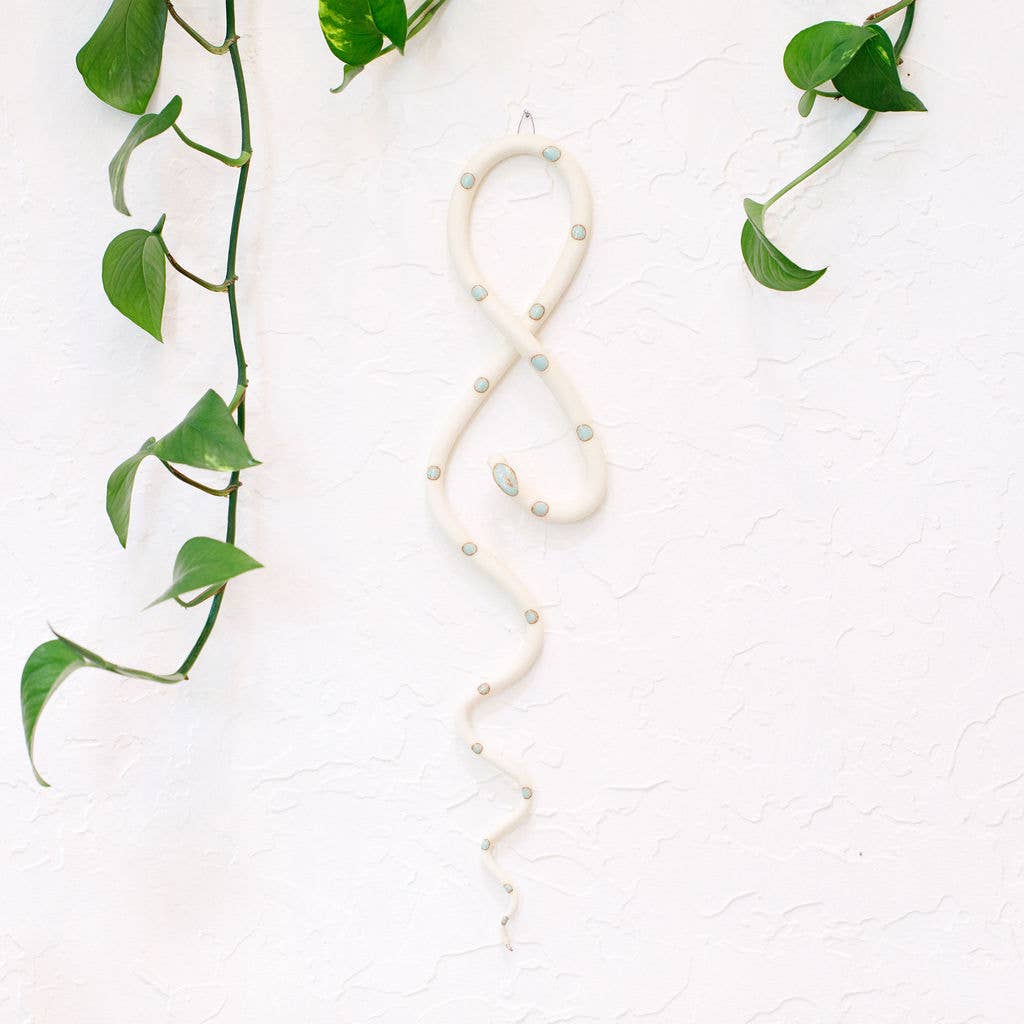 
                  
                    Ceramic snake wall art in white with mint spots
                  
                