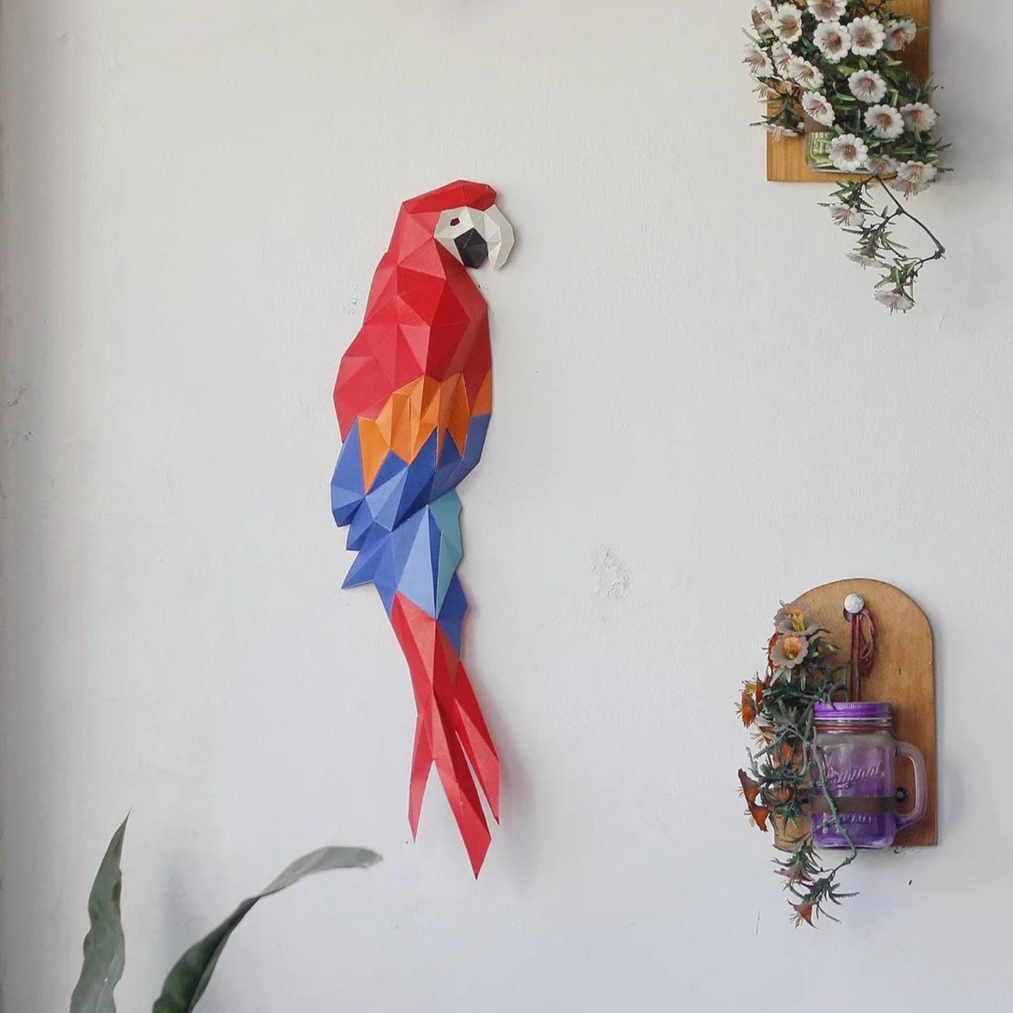 A low poly kirigami parrot from from a DIY 3D paper wall art template