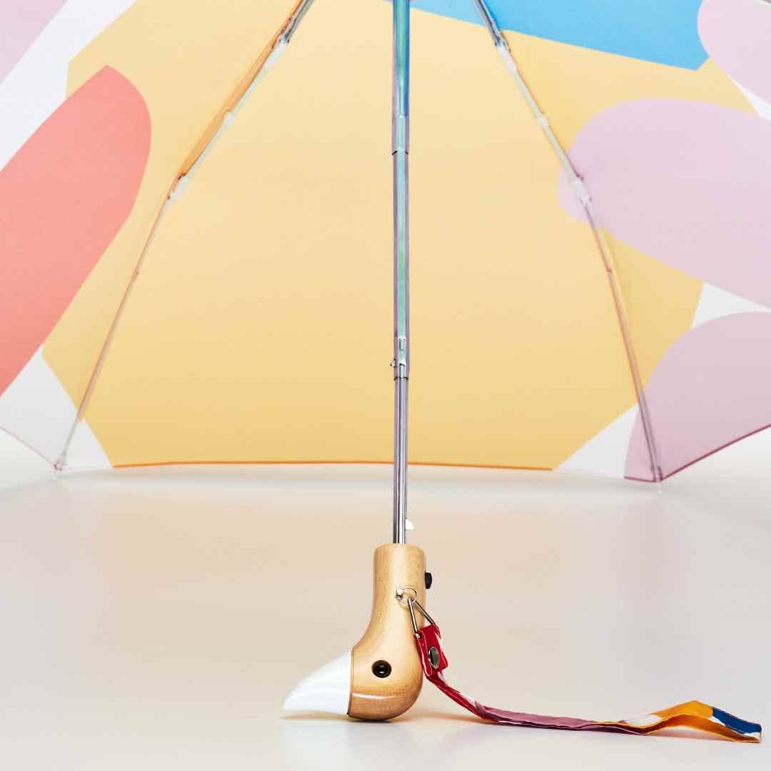 
                  
                    Close view of the duck head handle on the original duckhead umbrella. The colorful Matisse umbrella has a hand crafted wooden duck handle with a white beak.
                  
                