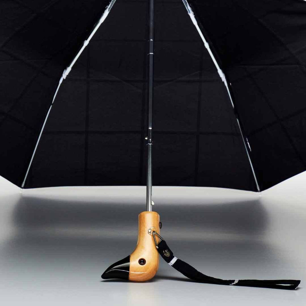 
                  
                    Close view of the duck head handle on the original duckhead umbrella. The black umbrella has a hand crafted wooden duck handle with a black beak.
                  
                