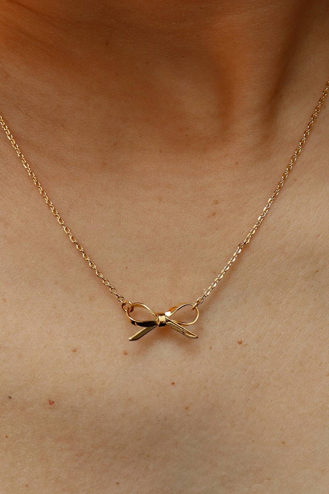 
                  
                    Delicate Gold Bow Necklace
                  
                