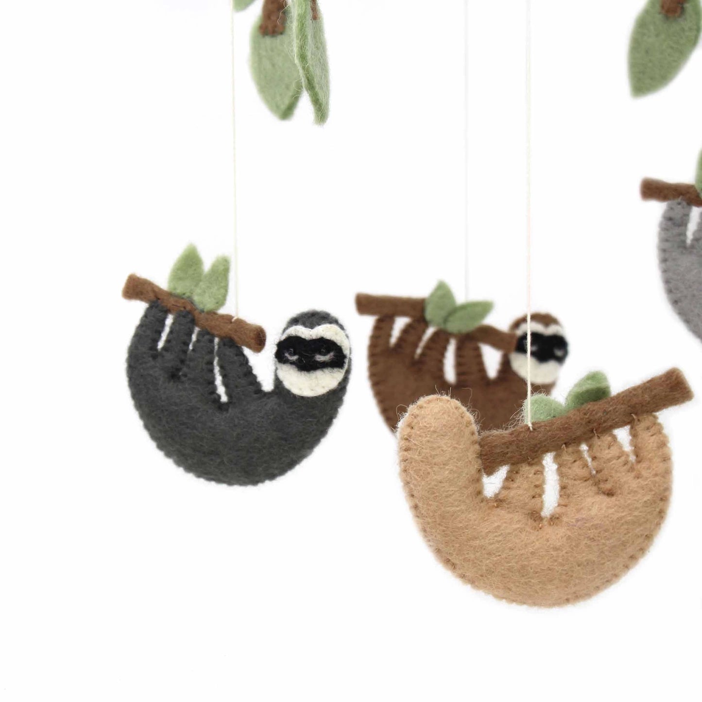 
                  
                    Close up of sloths on felt crib mobile
                  
                