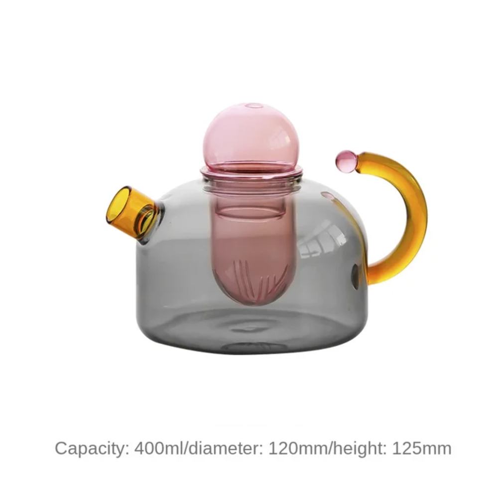 A glass teapot with built in tea strainer and lid in gray and pink