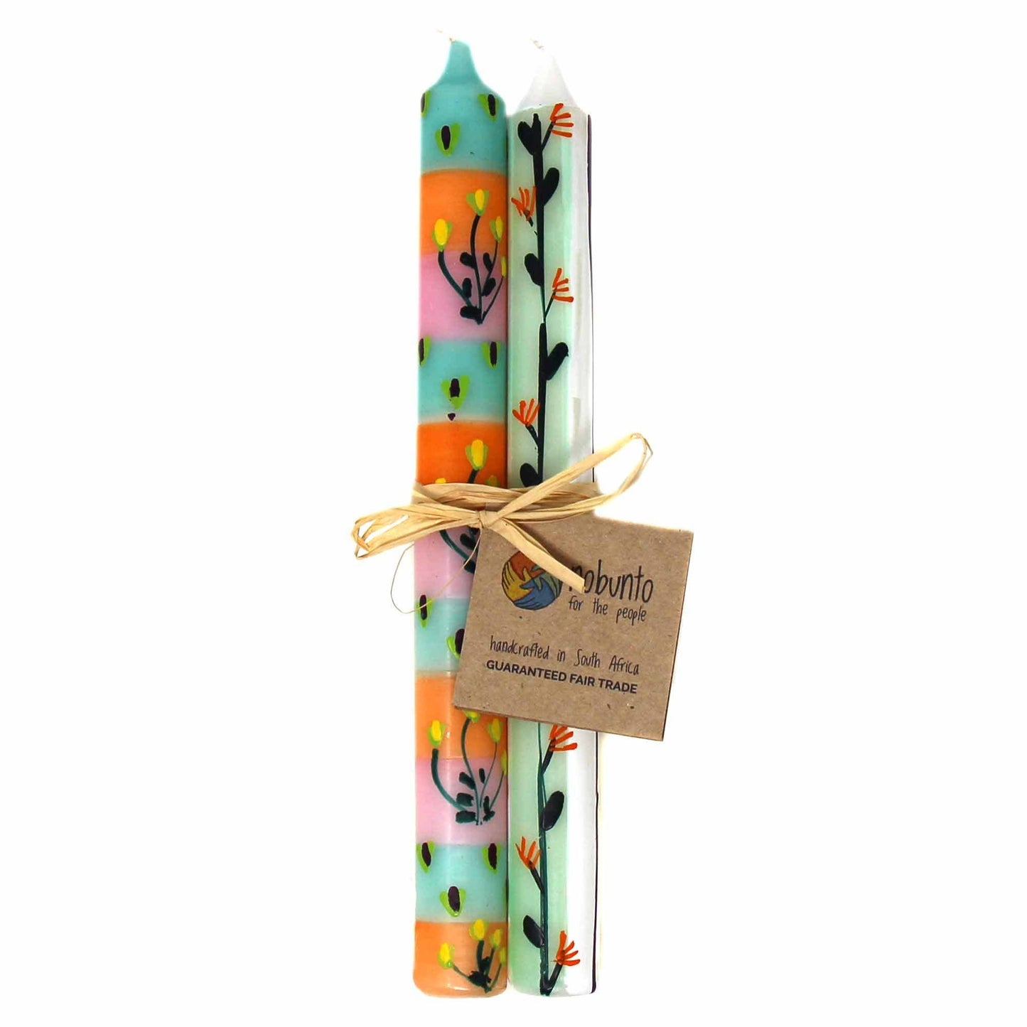 
                  
                    Three colorful candles with floral designs tied together with a brown ribbon and a visible brand tag on a white background.
                  
                