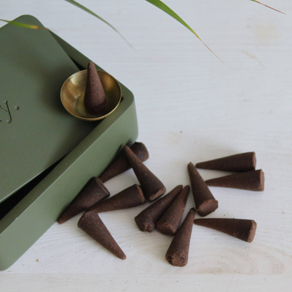 
                  
                    Incense cones with a brass dish in an elegant green clay box
                  
                