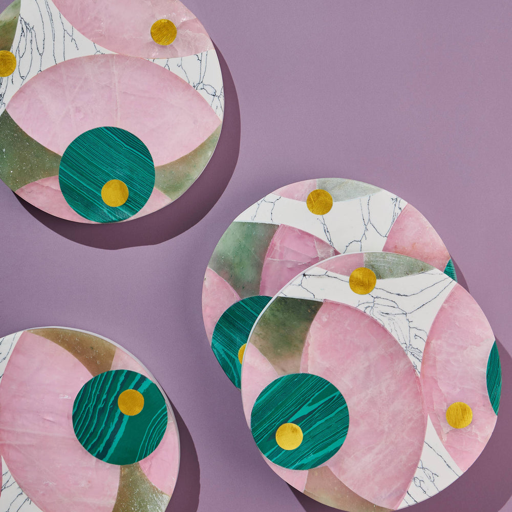 
                  
                    Four vibrant marble coasters with jade, rose, and light green marble panels and brass inlay
                  
                