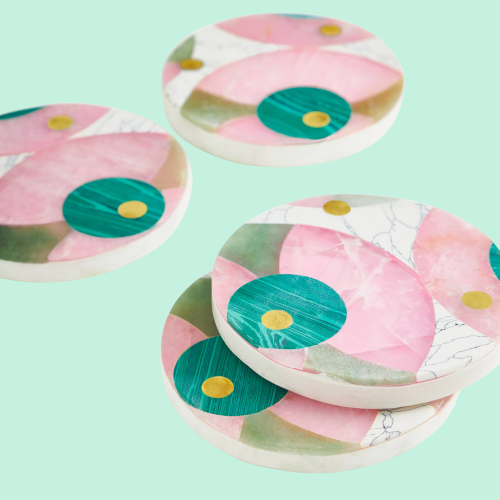 A set of 4 marble coasters with pink, blue, and light green marble panels