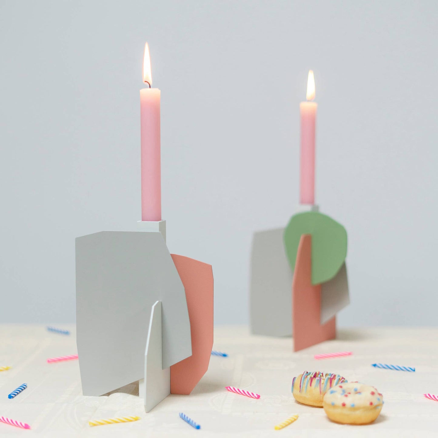 
                  
                    Matisse-inspired pastel metal candlestick holders with tapered candles
                  
                