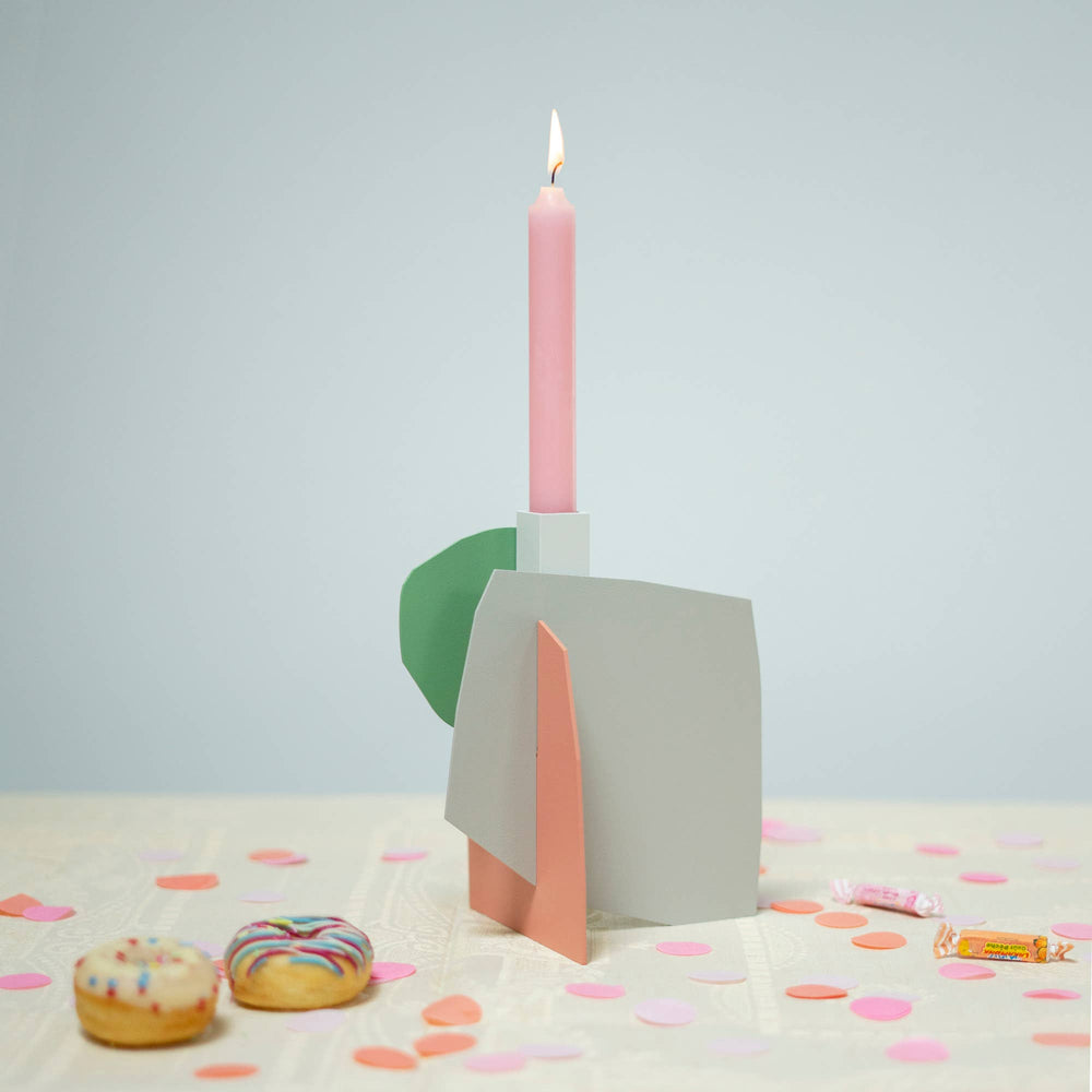 Matisse-inspired pastel metal candlestick holder on a table