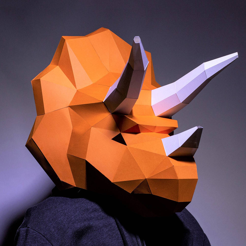 Man wearing triceratops paper mask craft in low poly orange color