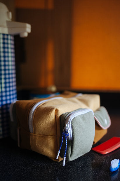 
                  
                    Toiletry style Sticky Lemon bags with large main pocket and two exterior color block pockets in green
                  
                