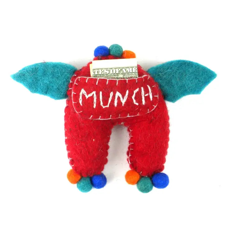 Tooth pocket on the back of a red monster tooth fairy pillow boy style with blue wings