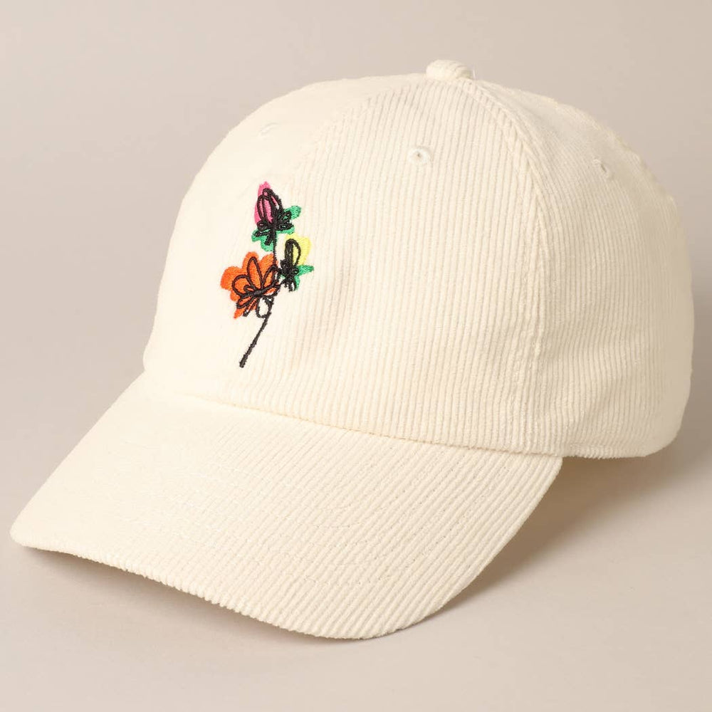 
                  
                    White corduroy baseball cap with embroidered flowers in orange, yellow, and purple
                  
                