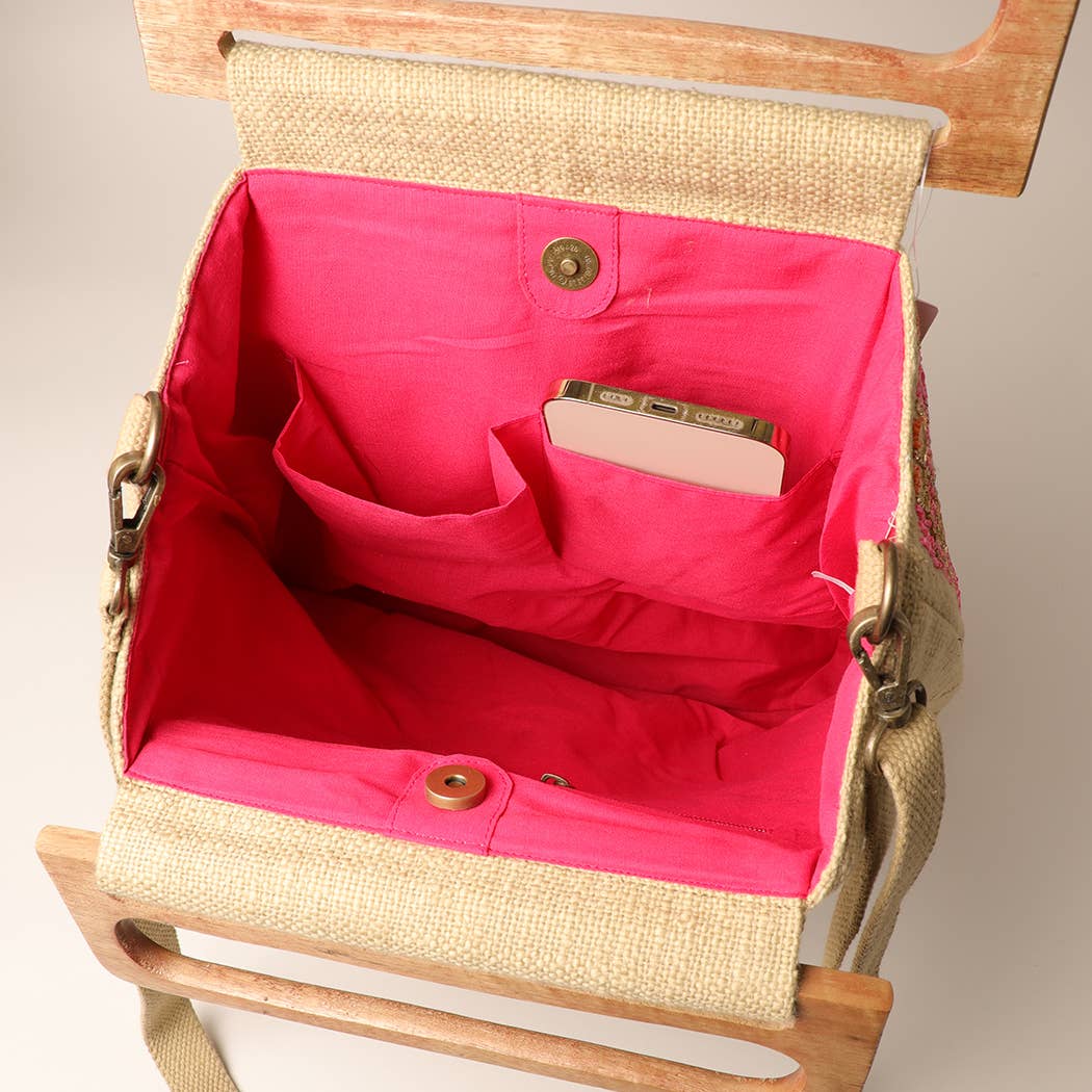 
                  
                    Inside view of the wide mouth opening of the wooden handle beaded summer bag. Pink lining with two pockets and zipper pouch.
                  
                
